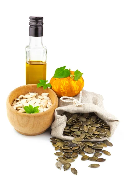 Sack of pumpkin seeds and bottle of oil — Stock Photo, Image