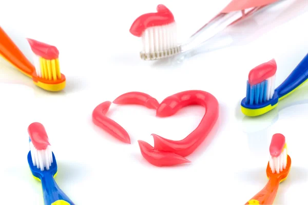 Toothbrushes with pink toothpaste — Stock Photo, Image