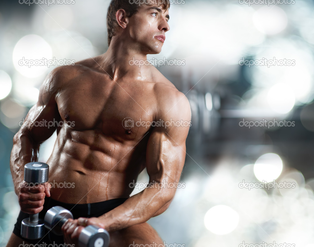Muscular guy with dumbbells