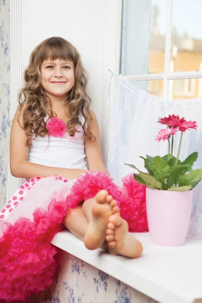 Girl teenager close-up sitting on windowsill near fresh flower — Stock Photo, Image