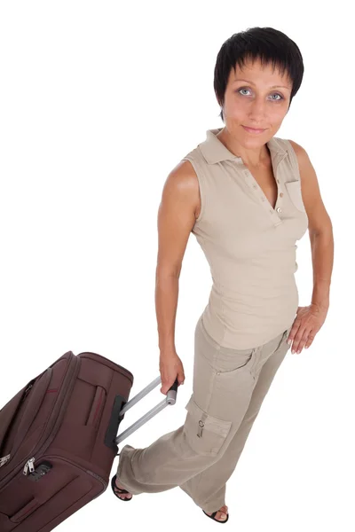 Young tourist woman stands with brown traveling suitcase isolate — Stock Photo, Image