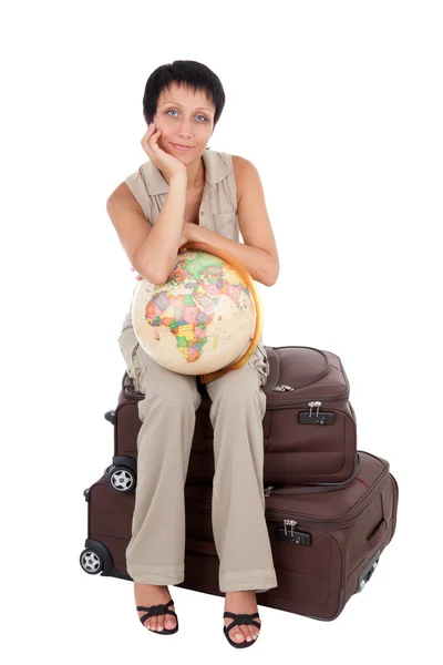 Young tourist woman sits on the brown traveling suitcase with g — Stock Photo, Image
