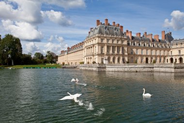 Medieval royal castle Fontainbleau and lake near Paris in France clipart
