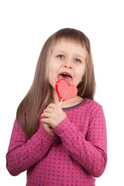 Little girl 7-8 years old licking red heart lollipop isolated clipart
