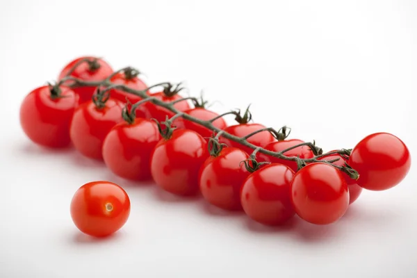 Bunch of ripe red cherry tomatoes close-up on white background — Stock Photo, Image