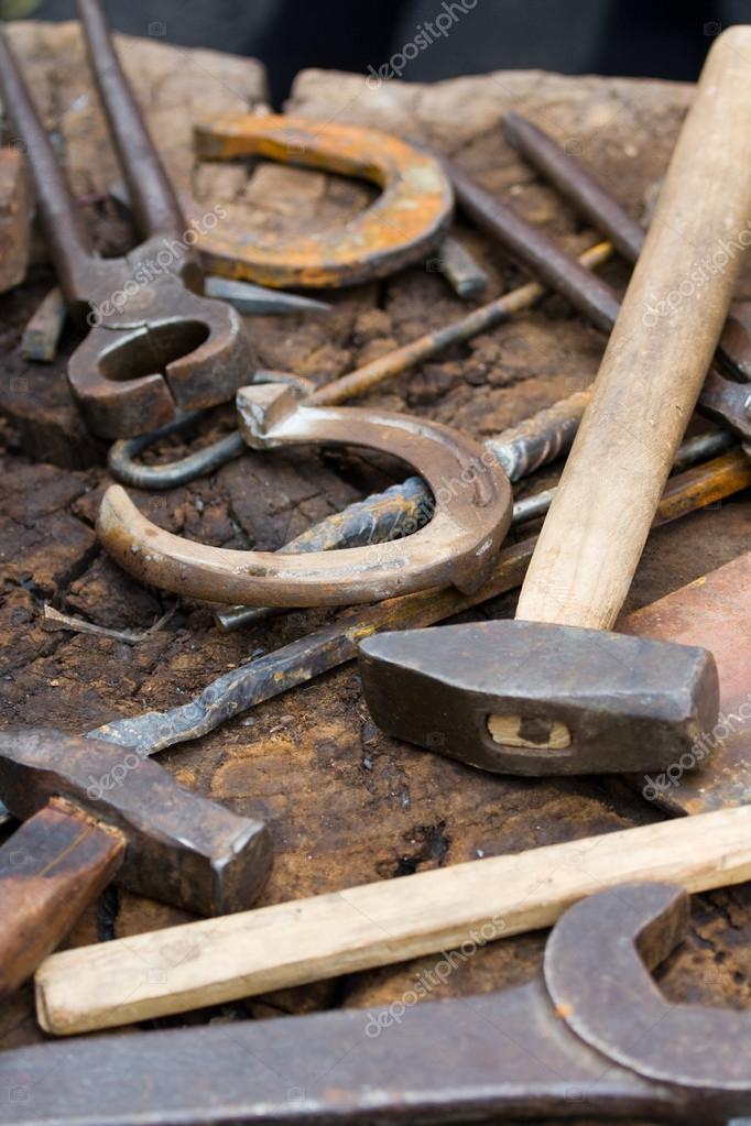 Rusty blacksmith tools and horseshoes — Stock Photo © SergeyAK 15340567