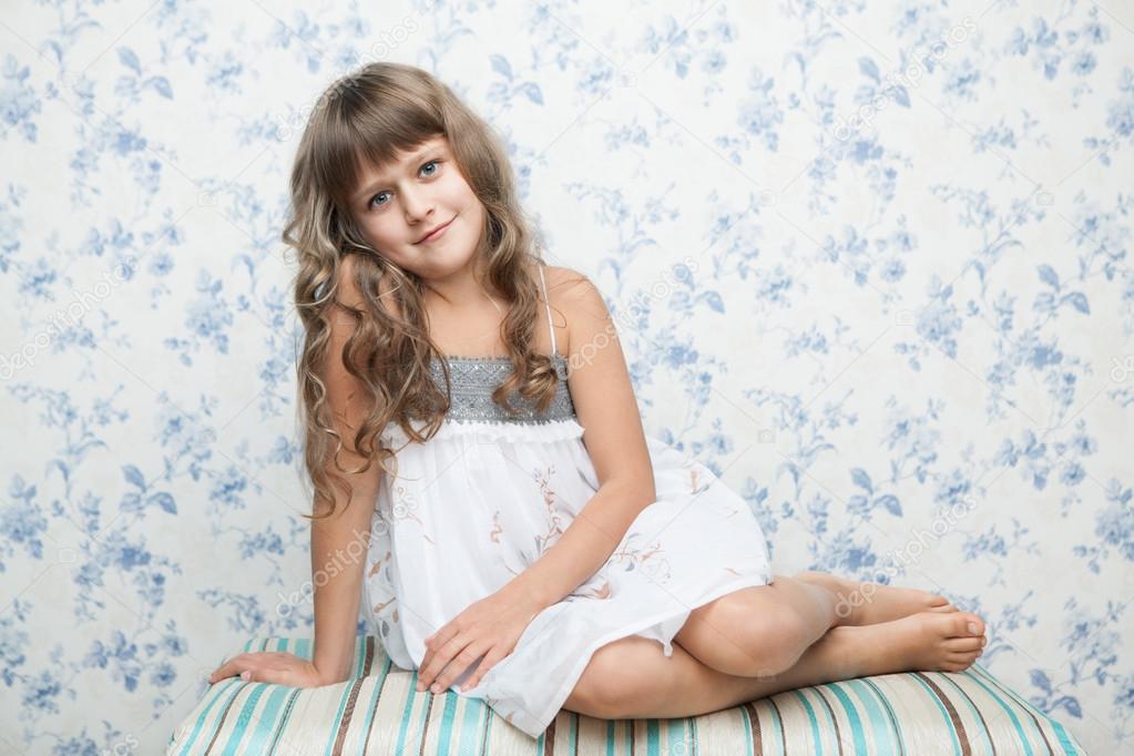 Portrait of sincere girl in sitting posture looking at camera