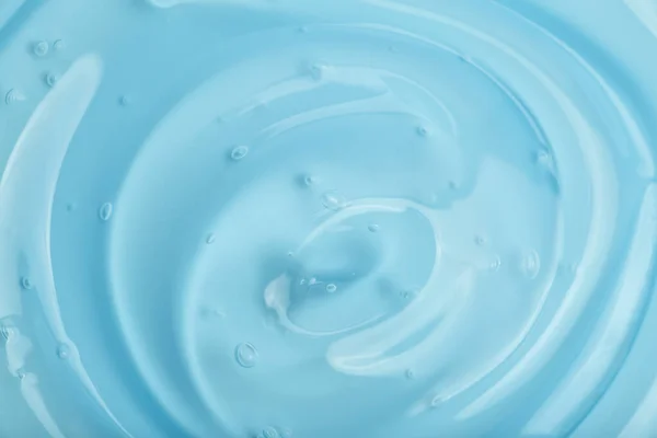 Kosmetisk gel bakgrund. Blå transparent gel med textur och bubblor på nära håll — Stockfoto