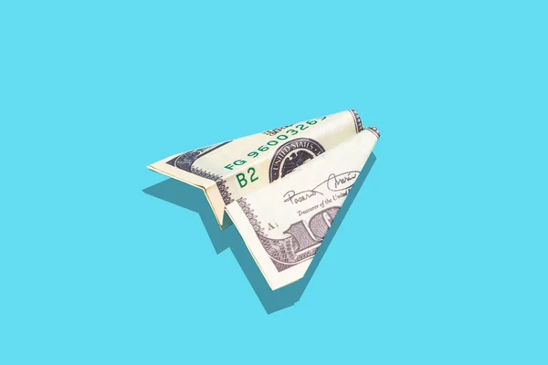 Travel flight money and money growth concept. US dollar airplane on blue minimal background. Income, budget, spending and business idea. — Stock Photo, Image