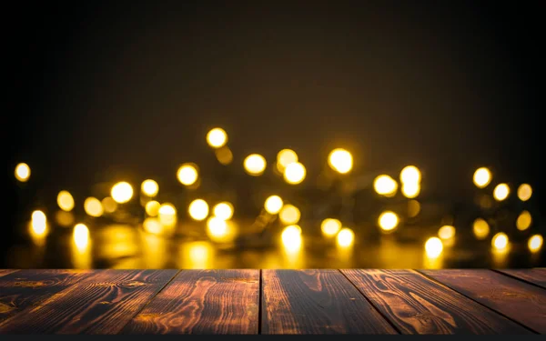 Table Christmas background. Lights of golden bokeh and wooden rustic texture surface for food, drinks and presents. — Stock Photo, Image