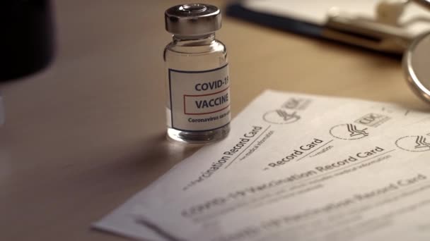 New York, USA - 08 November 2020. Vaccination card CDC to record doses of covid-19 coronavirus vaccine on the doctors table in the hospital — Stock Video