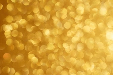  Altın bokeh arka planı. Doku folyosu ve konfeti bokeh, altın tozunun ışığı. Yılbaşı partisi ve yeni yıl arifesi geçmişi.