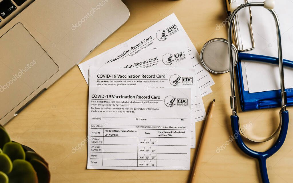 New York, USA - November 25 2021. Vaccination record card. Vaccination form during the coronavirus epidemic on the doctors table in the hospital. . High quality photo