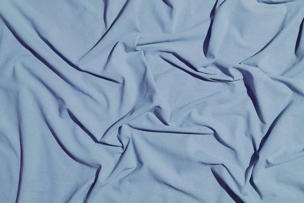 Katoenstof ondergrond. Vouwen, textuur en draperieën op het oppervlak textiel van kledingwarp, bekleding en design — Stockfoto