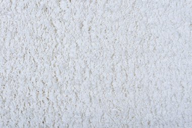 Halı dokusu arka planı. Zemin kaplamaları için beyaz pamuklu halı. Oturma odalarının iç tasarımı ve dekorasyonu için malzeme