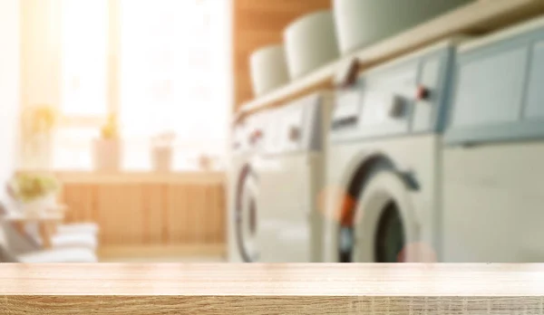 Laundry room table background. Blurred home laundry room with wooden table display for product. High quality photo