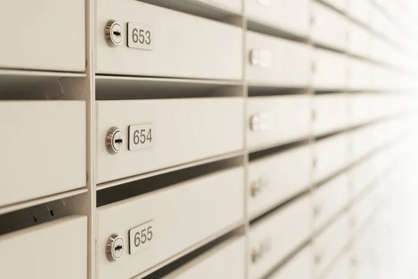 Mailboxes for letters and correspondence. Modern white mailboxes with numbers in the lobby of a residential or office building. High quality photo