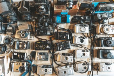 Berlin, Germany - August 14, 2022: Vintage cameras at the flea market. Old and used digital and film cameras for hipster photography. Lifestyle, retro concept. High quality photo