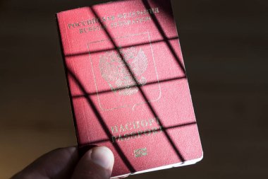 Russian foreign passport in the hands of a man. Prohibition of Schengen visas for Russian tourists to travel to the European Union concept. High quality photo