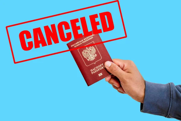 Russian foreign passport in the hands of a man. Prohibition of Schengen visas for Russian tourists to travel to the European Union concept. High quality photo
