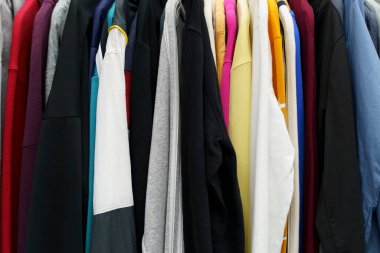 Second hand vintage clothes in a store on sale. Fashionable European used retro jeans, t-shirts, dresses, pants and accessories. Recycling and life extension for clothes concept. High quality photo