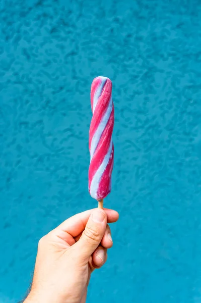 Ice cream cone in hand on minimal color background isolated. Summer, food, sweets, ice cream concept. High quality photo