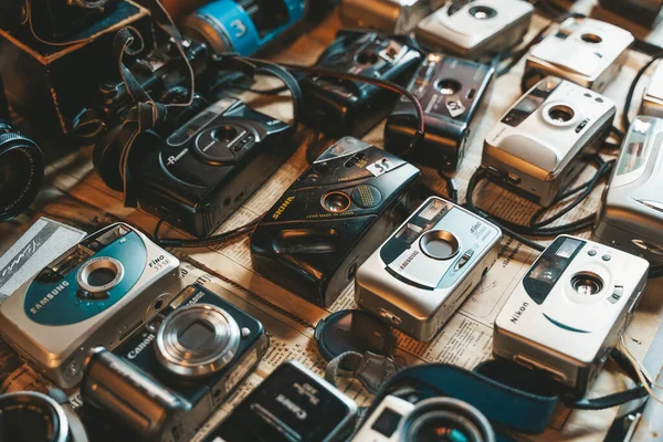 Berlin, Germany - August 14, 2022: Vintage cameras at the flea market. Old and used digital and film cameras for hipster photography. Lifestyle, retro concept. High quality photo