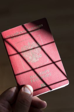 Russian passport in the hands of a man. Prohibition of Schengen visas for Russian tourists to travel to the European Union concept. High quality photo