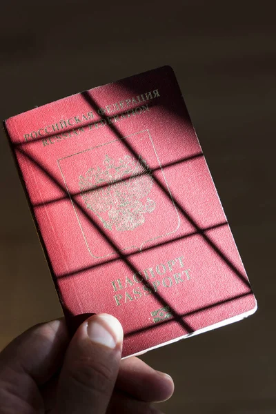 Russian passport in the hands of a man. Prohibition of Schengen visas for Russian tourists to travel to the European Union concept. High quality photo