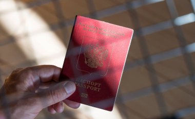 Russian passport in the hands of a man. Prohibition of Schengen visas for Russian tourists to travel to the European Union concept. High quality photo