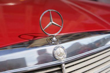 Berlin, Germany - August 20, 2022: Retro Mercedes Benz W123 230E and logo. Old fashioned European car. High quality photo
