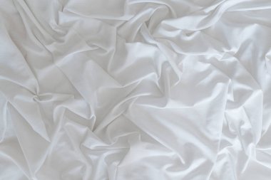 White drapery linen fabric background. Texture of the light surface of the fabric. High quality photo