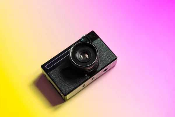 Vintage film camera on a color minimal background. Photography, hipster lifestyle concept. High quality photo