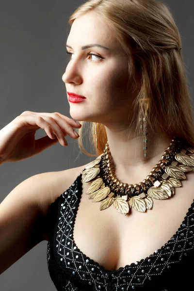 Woman putting on diamond earrings. Caucasian beauty lady trying and shopping jewelry.