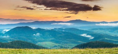 Dağlarda sis olan sonbahar manzarası. Tepelerdeki orman.