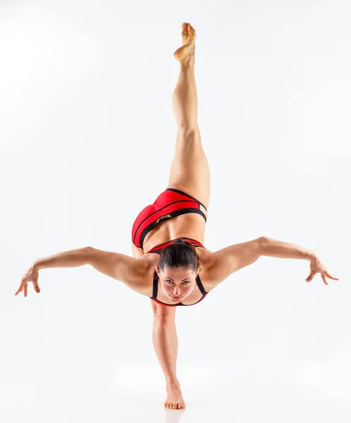 Sporty beautiful young woman practicing yoga, doing lunge exercise, Revolved Side Angle Pose, , working out wearing red and black sportswear, studio full length, isolated white background. — Stock Photo, Image