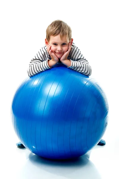 Criança sorridente em uma bola de exercício — Fotografia de Stock