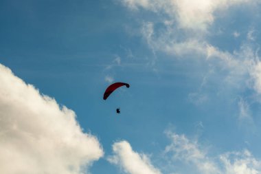 Yaz günü bulutlar üzerinde uçan Yamaçparaşütü