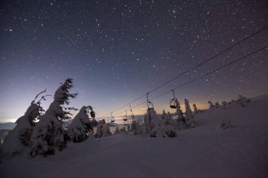 Fantastik yıldızlı gökyüzü. Kış manzarası ve karla kaplı zirveler. Karpat Dağları. Ukrayna. Avrupa