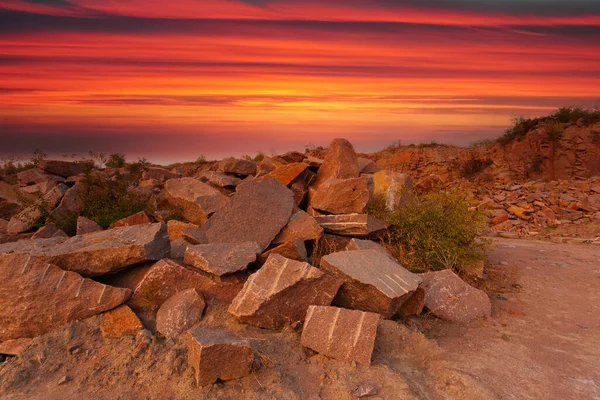Ukrayna 'da granit madeninde kayalar ve ön planda büyük taşlar bulunan bir çöl manzarası..