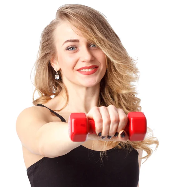 Young fitness model posing in studio. Healthy young woman in sportswear standing on grey background — стоковое фото