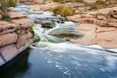 Kayaların üzerinden akan güzel dağ nehri. Dağ nehrinde akan su, yaklaş.