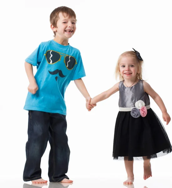 Portrait of a brother and sister, curly blond with blue eyes laughing merrily on a white background. Childrens emotions, happiness, joy, fun. Beautiful cute children. Friendship. — Fotografia de Stock