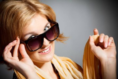 portrait of beautiful young woman of blonde is in sunglasses