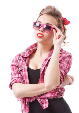 Coquettish girl in silk dress and glasses licks her finger and holds martini