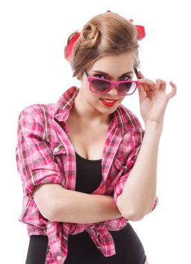 Coquettish girl in silk dress and glasses licks her finger and holds martini