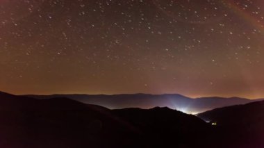 Stars over Carpatian Mountains. Wonderful incredible night sky over Kamenka. A cinematic magical view of the universal space with millions of shining stars. Synevyr Pass, Carpathians, Ukraine.