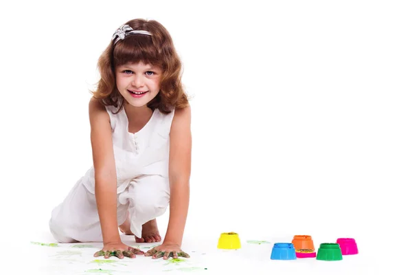 Portrait of pretty little girl painting picture on a white background — Stock fotografie
