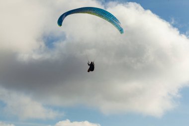 Yaz günü bulutlar üzerinde uçan Yamaçparaşütü