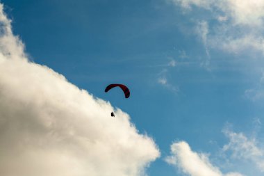 Yaz günü bulutlar üzerinde uçan Yamaçparaşütü